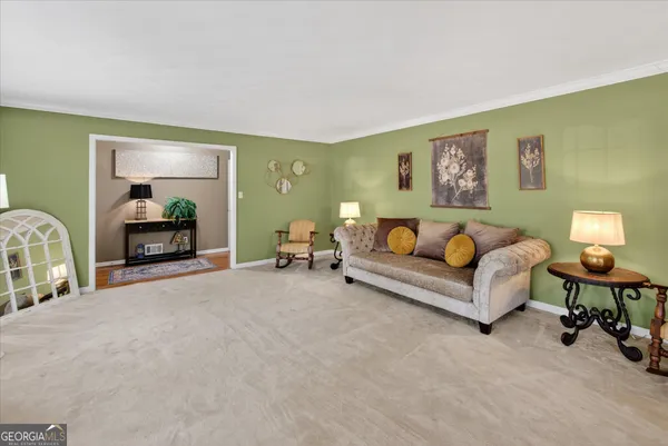 a spacious bedroom with a bed and a lamp