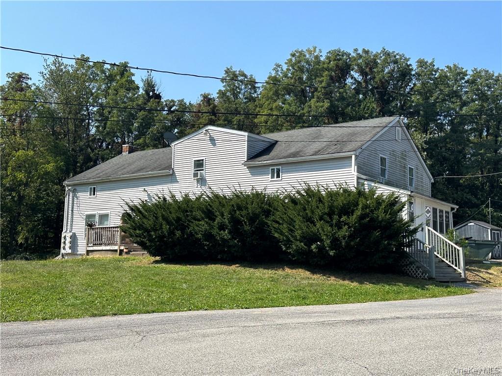 View of side of property with a lawn