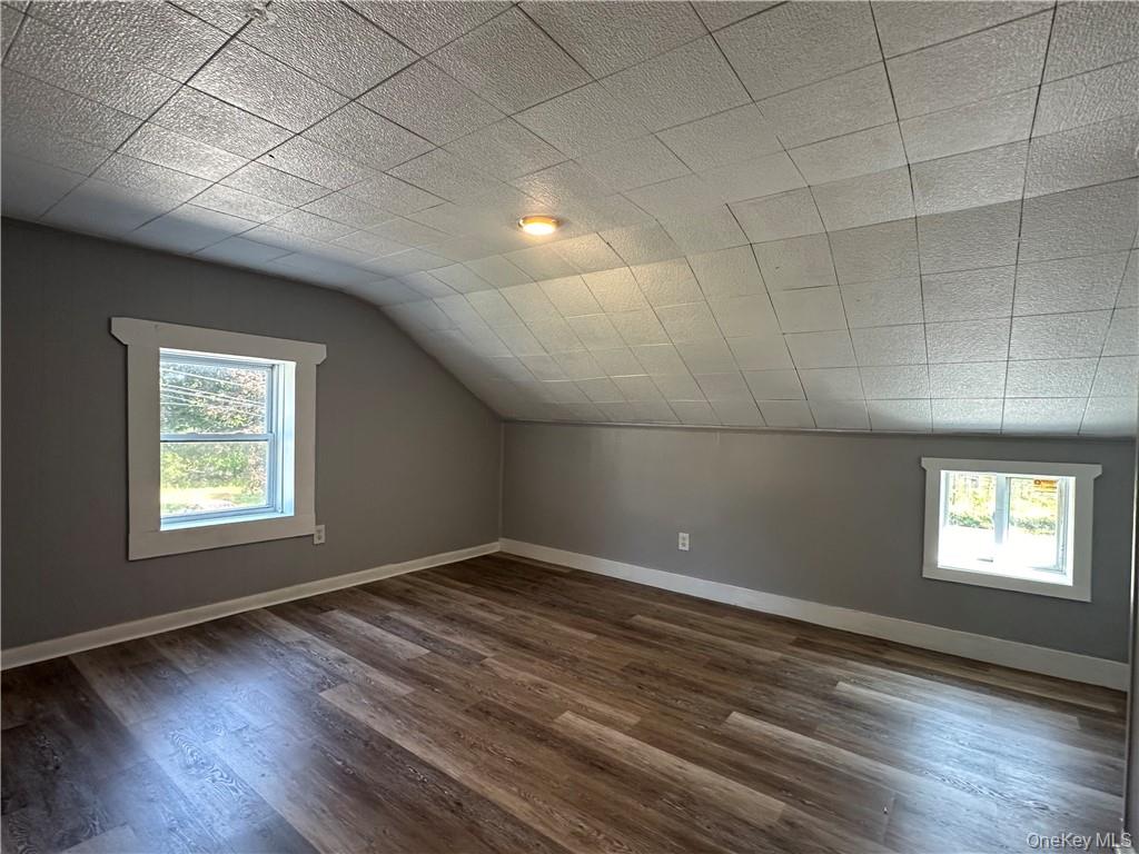 1399 State Rte 55, Unit 11 Clintondale, NY 12515 - Photo 11 of 21 Bonus room with a wealth of natural light, lofted ceiling, and dark hardwood / wood-style flooring