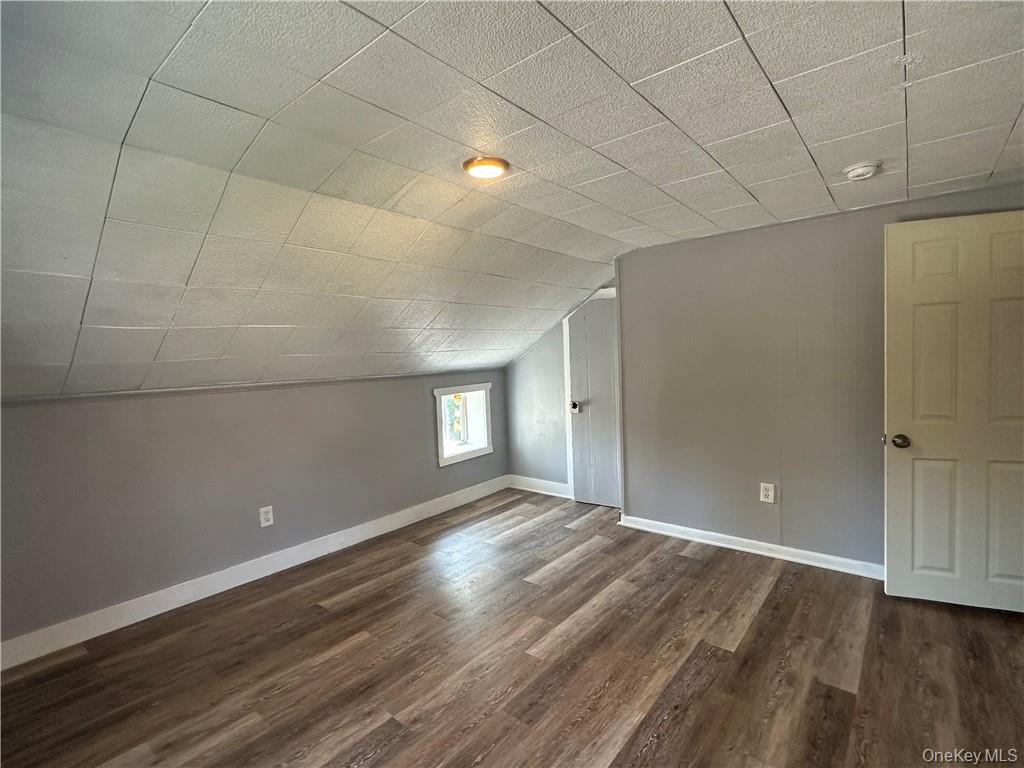 1399 State Rte 55, Unit 11 Clintondale, NY 12515 - Photo 12 of 21 Additional living space featuring lofted ceiling and dark hardwood / wood-style flooring
