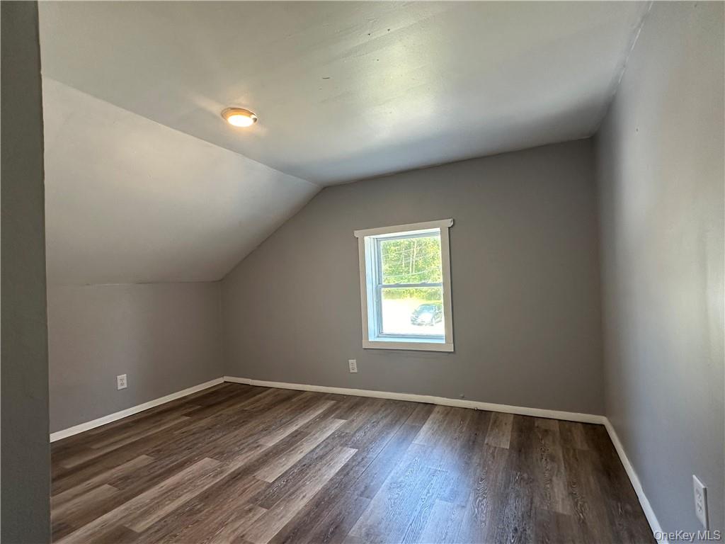 1399 State Rte 55, Unit 11 Clintondale, NY 12515 - Photo 13 of 21 Bonus room with dark hardwood / wood-style floors and vaulted ceiling