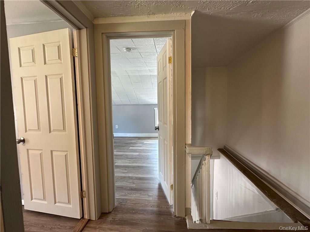 1399 State Rte 55, Unit 11 Clintondale, NY 12515 - Photo 18 of 21 Hallway with a textured ceiling and dark hardwood / wood-style flooring