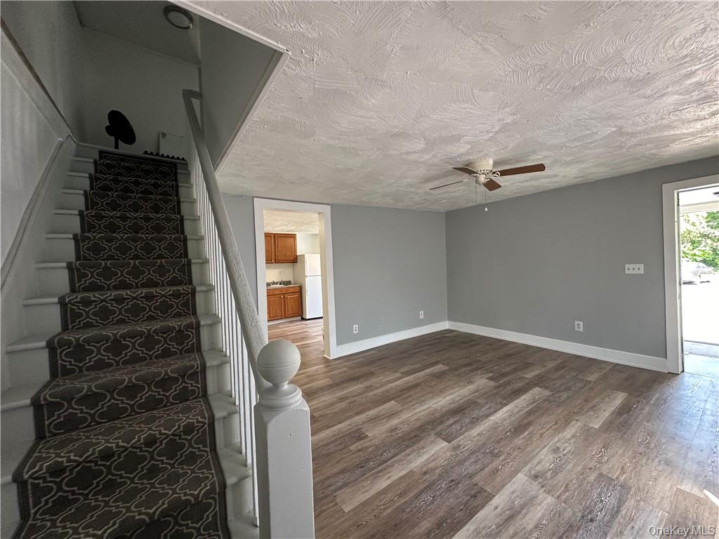 1399 State Rte 55, Unit 11 Clintondale, NY 12515 - Photo 21 of 21 Staircase featuring a textured ceiling, hardwood / wood-style flooring, and ceiling fan