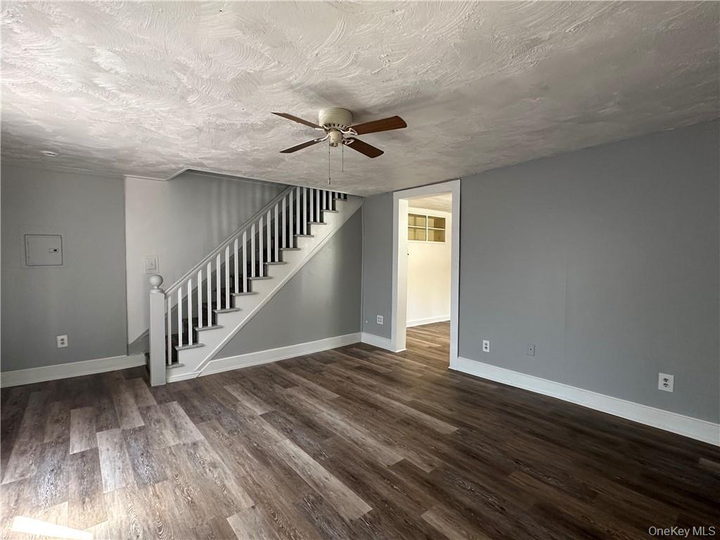 1399 State Rte 55, Unit 11 Clintondale, NY 12515 - Photo 8 of 21 Spare room with ceiling fan, a textured ceiling, and dark hardwood / wood-style floors