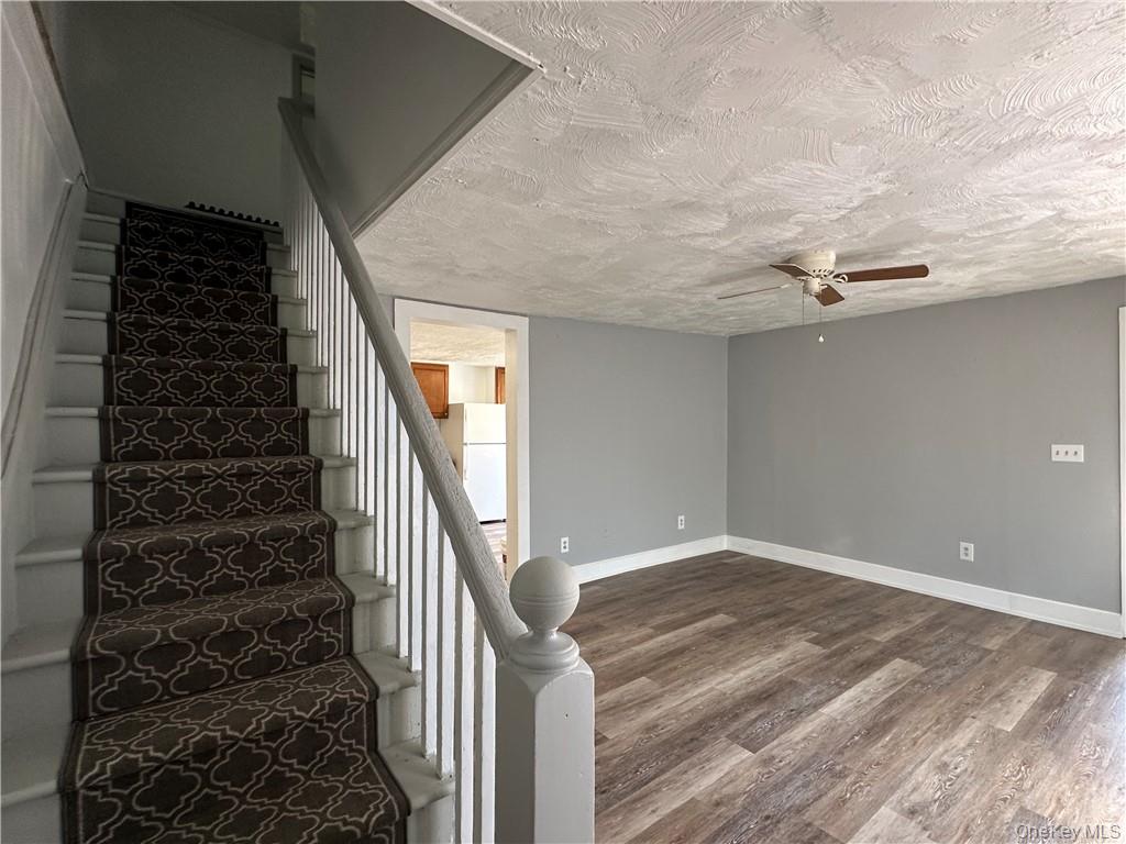 1399 State Rte 55, Unit 11 Clintondale, NY 12515 - Photo 10 of 21 Stairway featuring a textured ceiling, hardwood / wood-style flooring, and ceiling fan