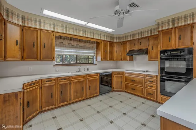 a kitchen with stainless steel appliances granite countertop a sink and cabinets