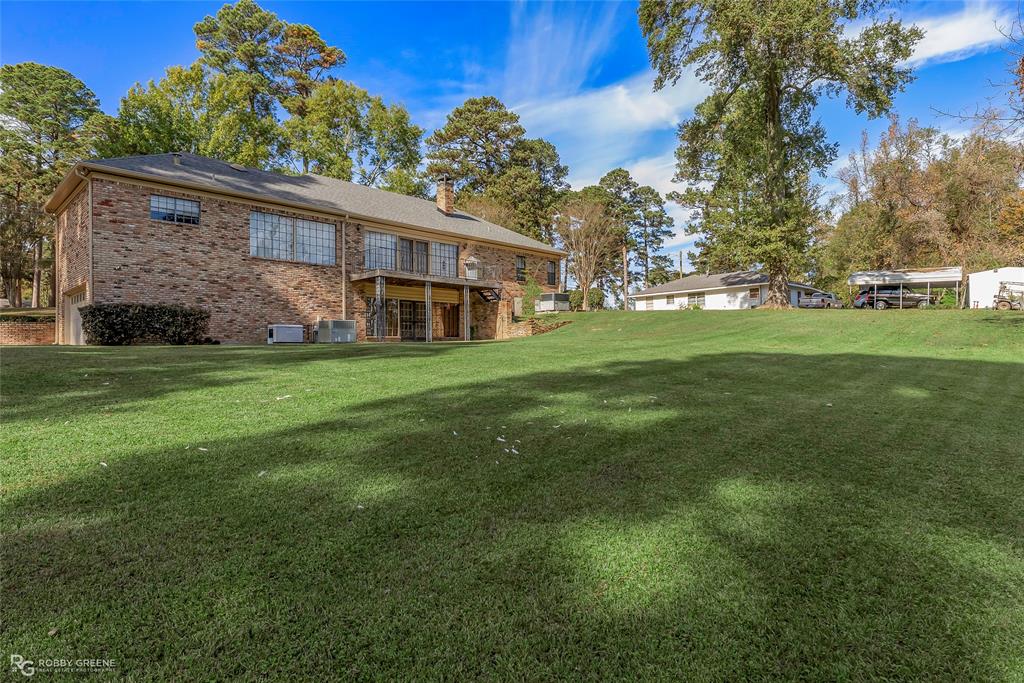3073 Risinger Drive Shreveport, LA 71119 - Photo 4 of 39 a front view of a house with a garden