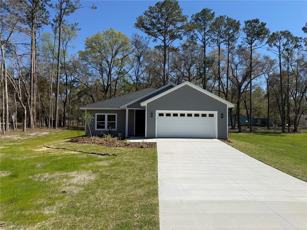 a front view of house with yard and trees