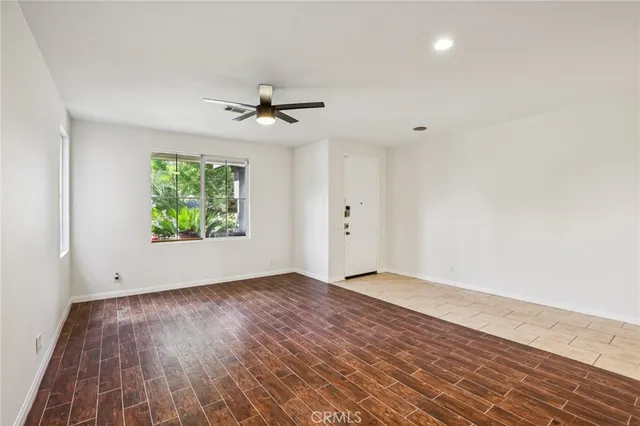 a kitchen with stainless steel appliances granite countertop a stove a sink dishwasher and a microwave oven with wooden cabinets