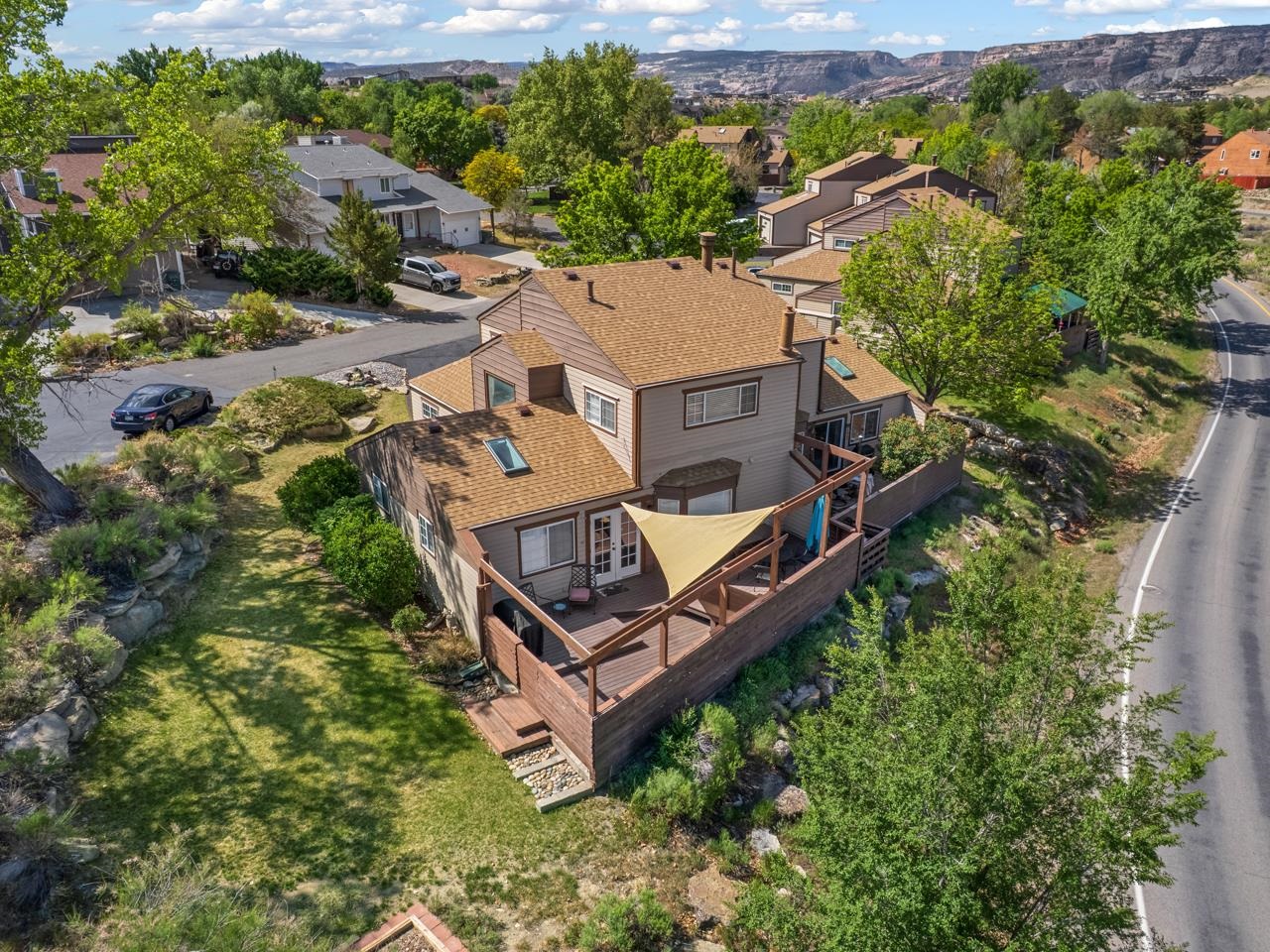 383 Explorer Court, Unit B Grand Junction, CO 81507 - Photo 40 of 40 an aerial view of a house with a big yard and large trees
