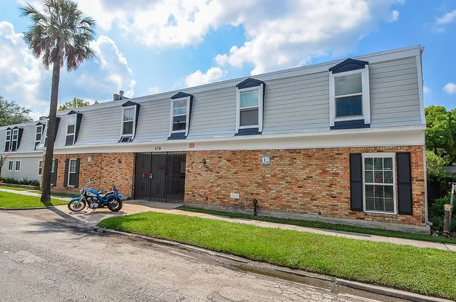 a view of a house with a yard and pathway
