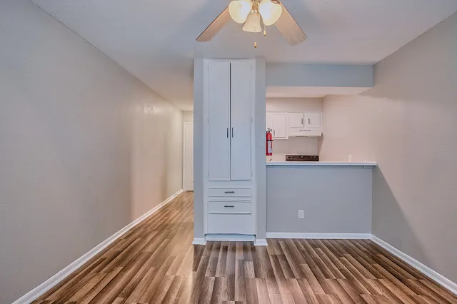 a view of kitchen with wooden floor and electronic appliances