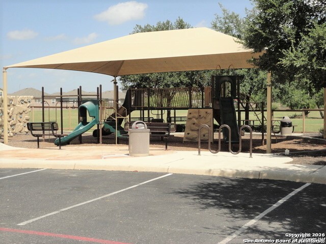 7136 Quarter Moon Converse, TX 78109 - Photo 20 of 22 a view of a patio with a table and chairs under an umbrella