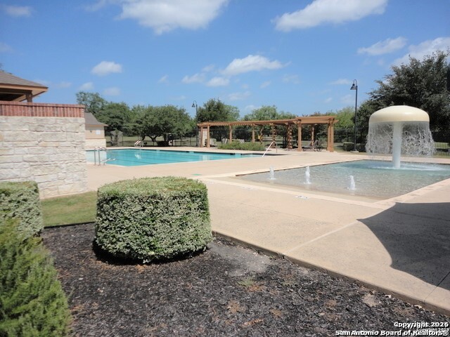 7136 Quarter Moon Converse, TX 78109 - Photo 21 of 22 a view of a swimming pool with an outdoor seating and a garden