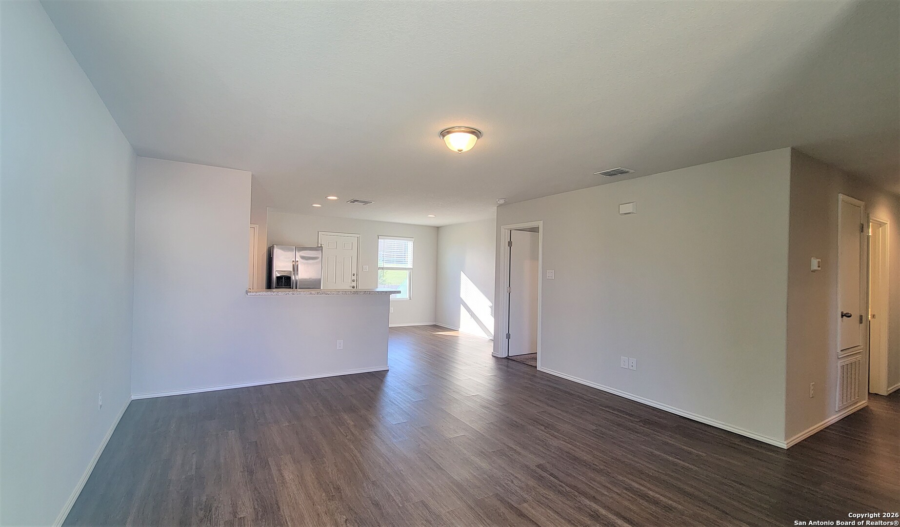 7136 Quarter Moon Converse, TX 78109 - Photo 5 of 22 a view of a big room with wooden floor and windows
