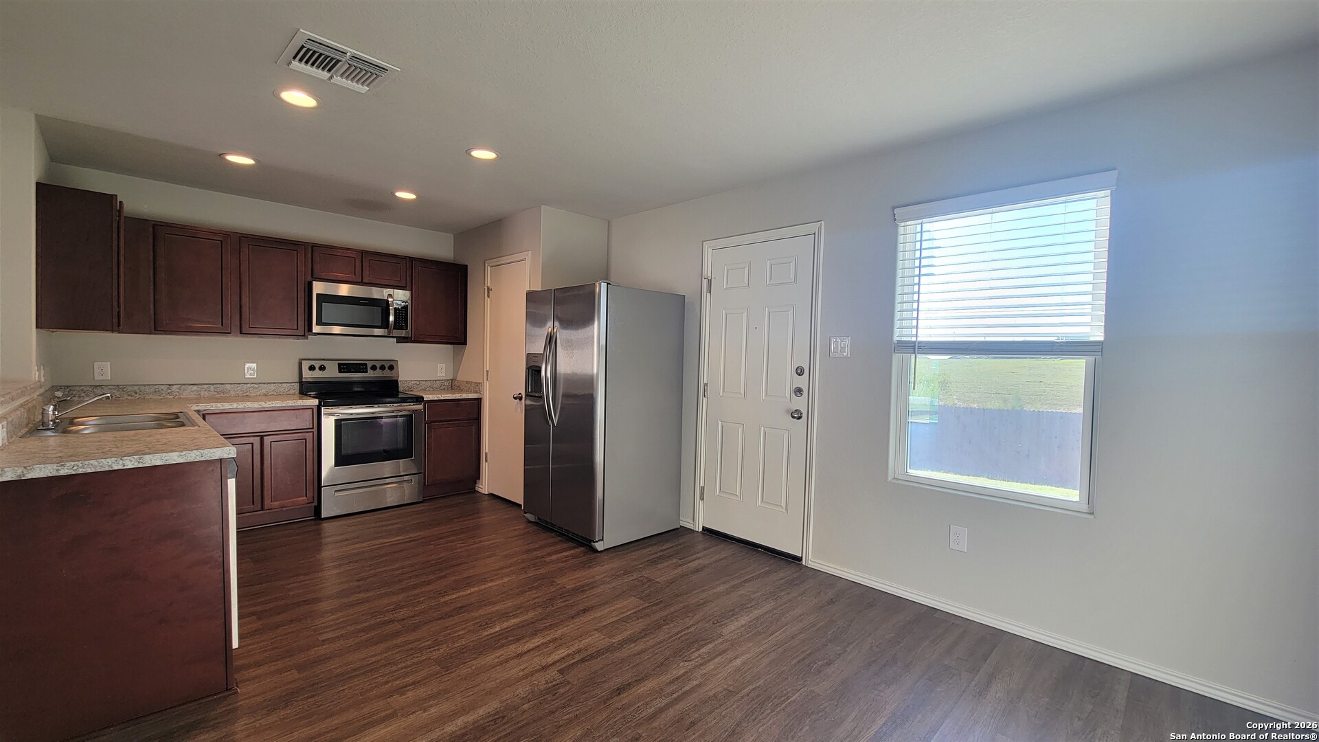 7136 Quarter Moon Converse, TX 78109 - Photo 6 of 22 a kitchen with a refrigerator and a stove top oven