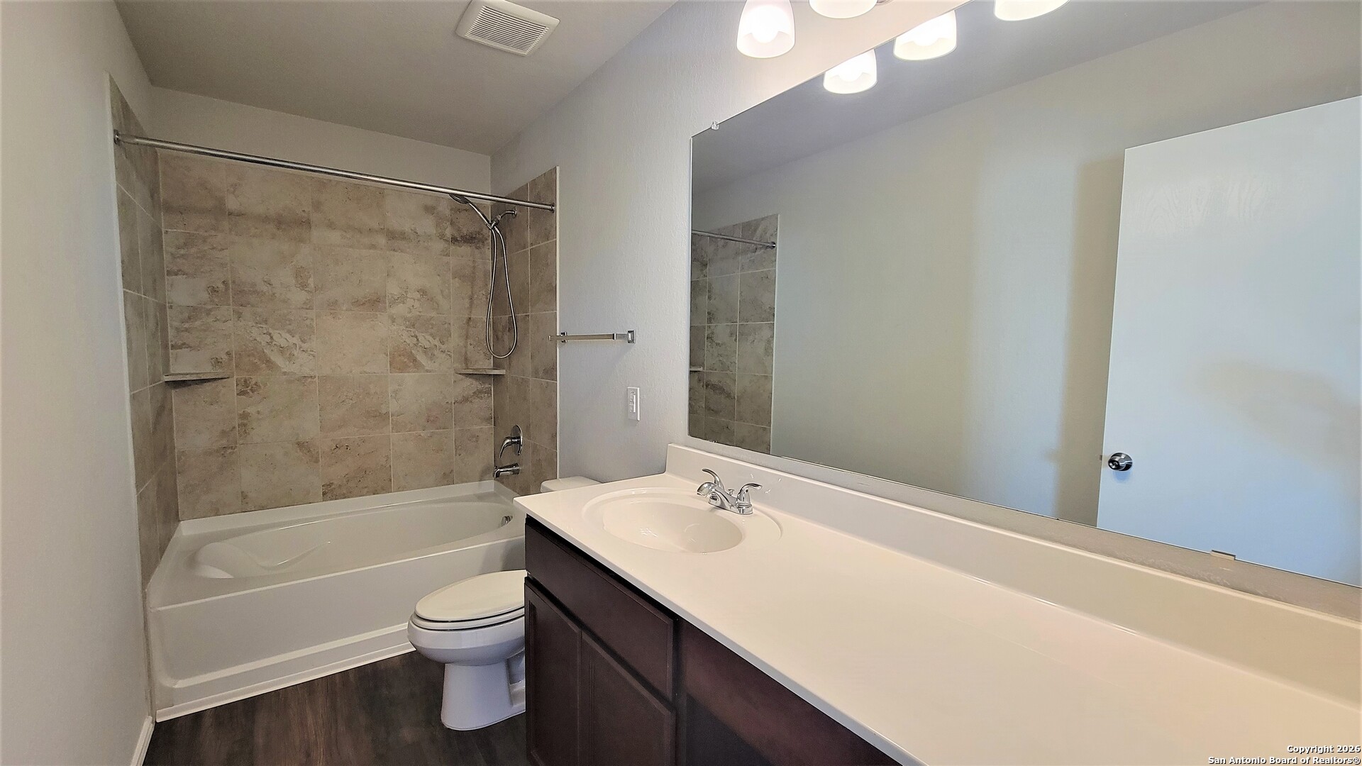 7136 Quarter Moon Converse, TX 78109 - Photo 10 of 22 a bathroom with a bathtub shower sink vanity and toilet