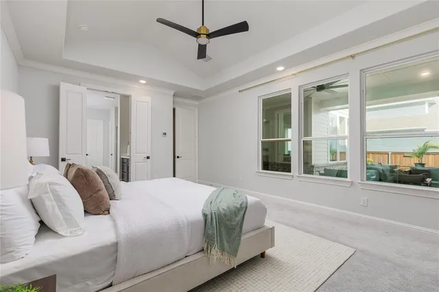 a bedroom with a large bed and a large window