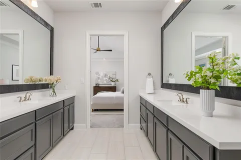 a en suite bathroom with double sink and a mirror