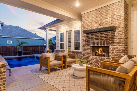 a living room with patio furniture and a fireplace