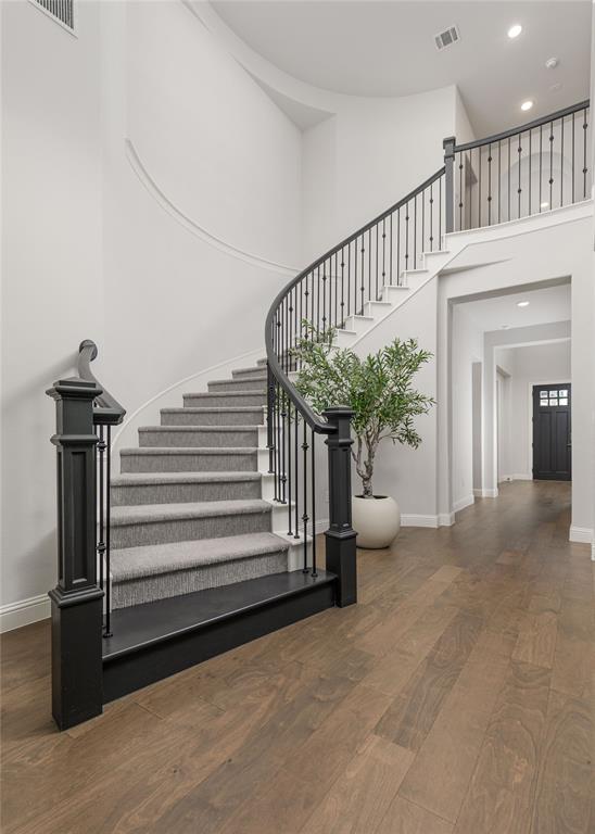 7409 Cormac Street McKinney, TX 75071 - Photo 25 of 40 Curved staircase is a showstopper in the entry way.