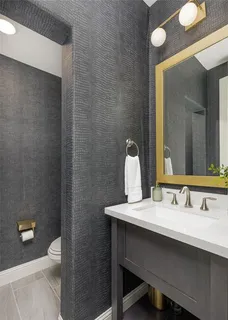 a bathroom with a sink a toilet and a mirror