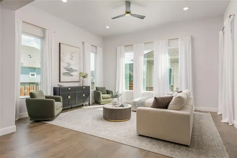 a living room with furniture and a potted plant