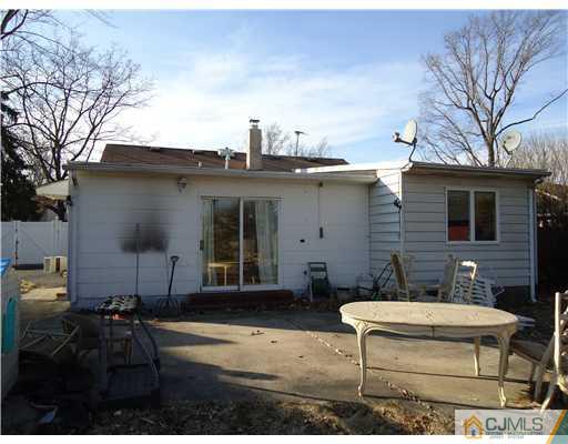 12 Crescent Road Edison, NJ 08817 - Photo 3 of 11 a view of a patio with table and chairs a barbeque with wooden fence