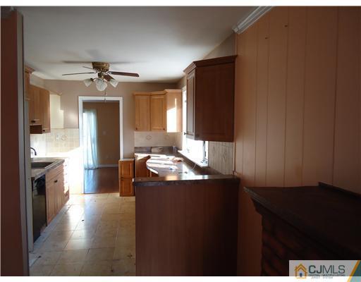 12 Crescent Road Edison, NJ 08817 - Photo 4 of 11 a kitchen with kitchen island sink and refrigerator