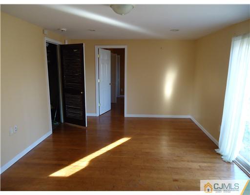 12 Crescent Road Edison, NJ 08817 - Photo 5 of 11 a view of an empty room with wooden floor