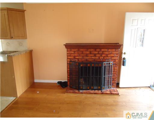 12 Crescent Road Edison, NJ 08817 - Photo 8 of 11 a view of an empty room with a fireplace