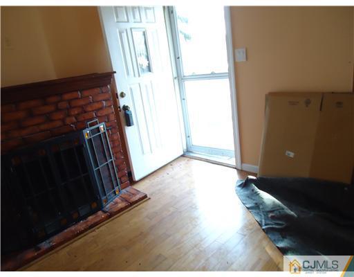 12 Crescent Road Edison, NJ 08817 - Photo 10 of 11 a view of an empty room with wooden floor and a window