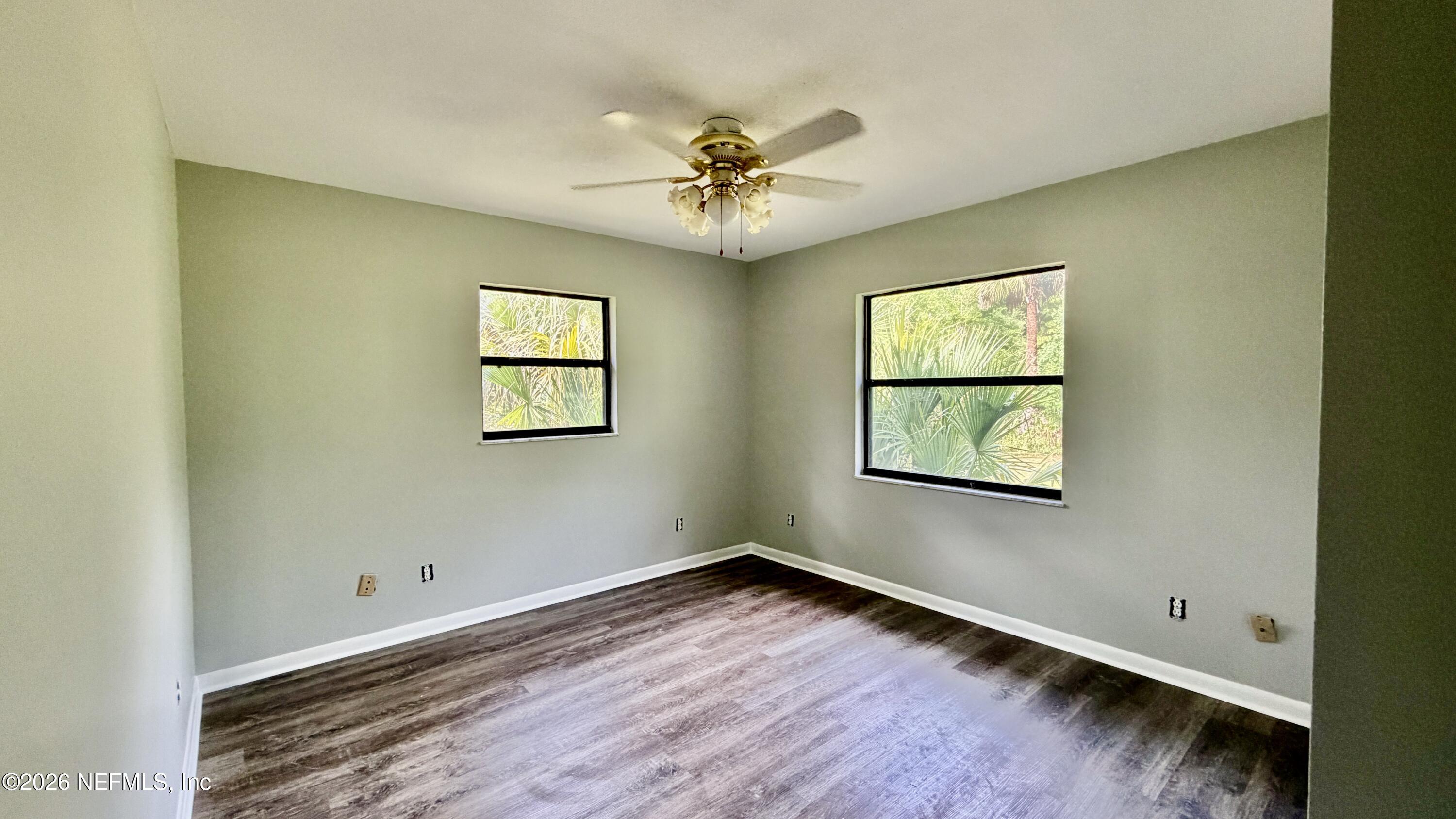 850 Cousintown Road Interlachen, FL 32148 - Photo 12 of 27 a view of an empty room with window and wooden floor