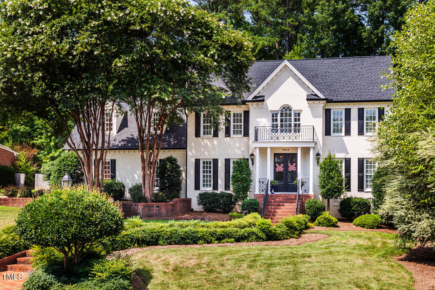 7404 Wingfoot Drive Raleigh, NC 27615 - Photo 1 of 61 a front view of a house with a yard and trees