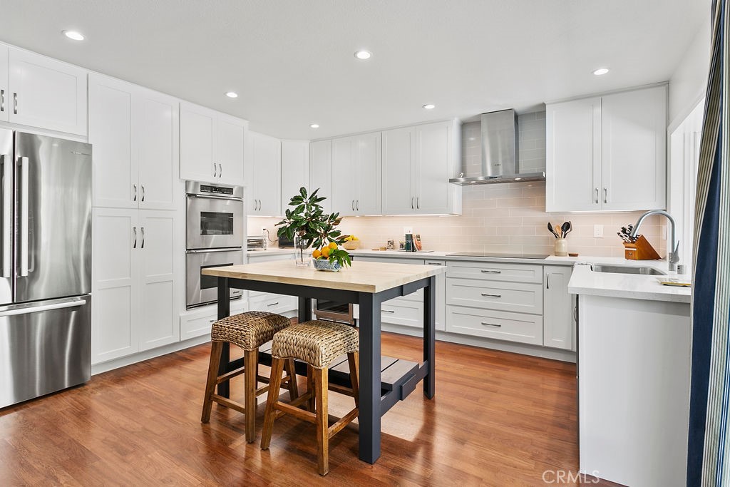 27242 Cordero Lane Mission Viejo, CA 92691 - Photo 12 of 39 a kitchen with a table chairs refrigerator and microwave