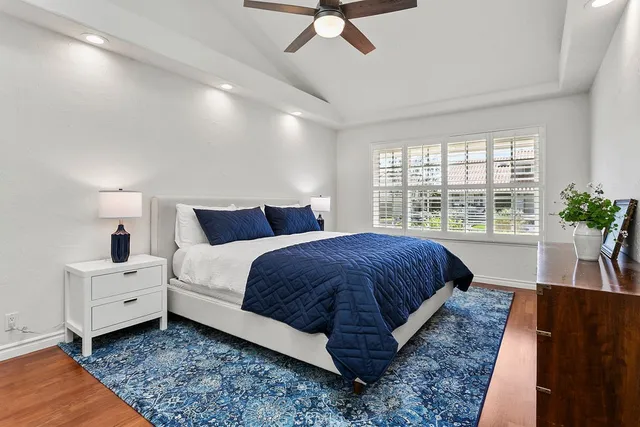 a bedroom with bed and a large window