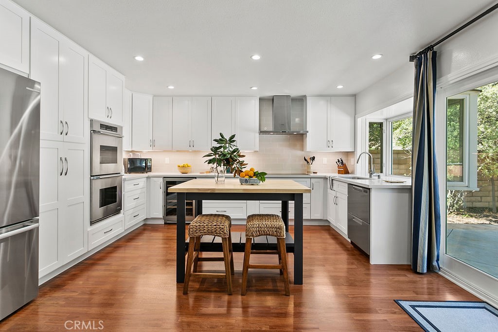 27242 Cordero Lane Mission Viejo, CA 92691 - Photo 10 of 39 a kitchen with a table chairs refrigerator and microwave