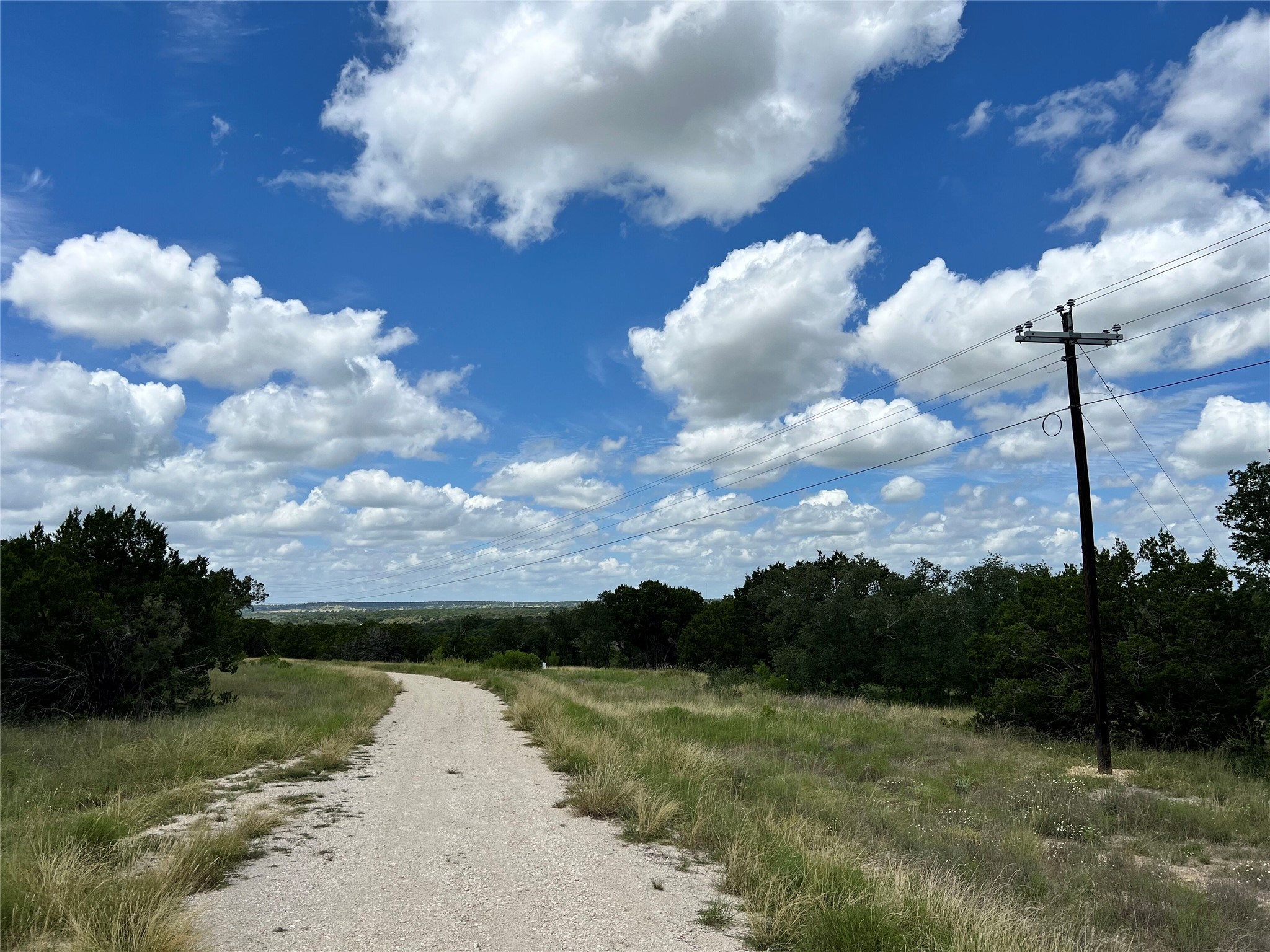 2452 Stone Creek Ranch Drive Evant, TX 76525 - Photo 12 of 19 a view of a pathway both side of grassy field with shrub