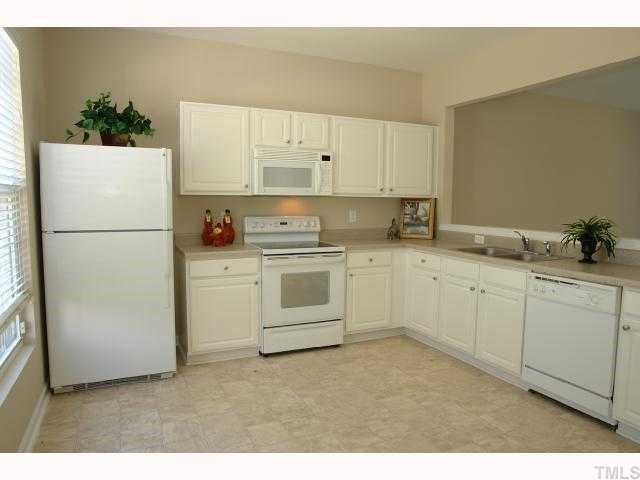 5018 Echo Ridge Road Raleigh, NC 27612 - Photo 3 of 12 a kitchen with white cabinets and white appliances