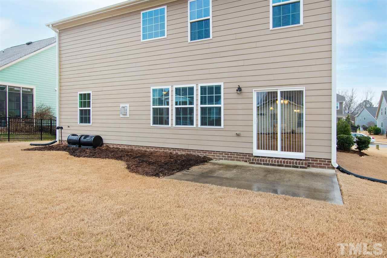 1013 Traditions Meadow Drive Wake Forest, NC 27587 - Photo 13 of 30 a front view of a house with a yard and garage