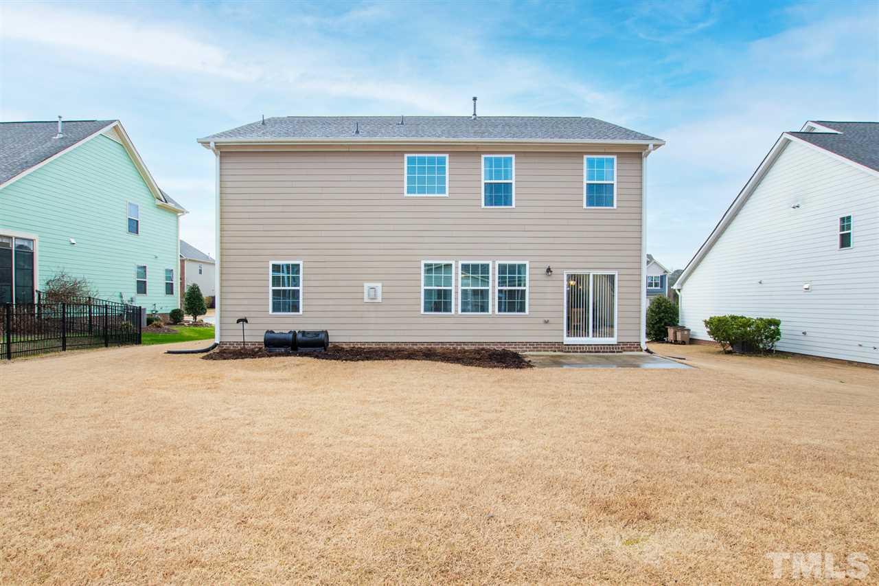 1013 Traditions Meadow Drive Wake Forest, NC 27587 - Photo 14 of 30 a backyard of a house with barbeque oven and a table and chairs