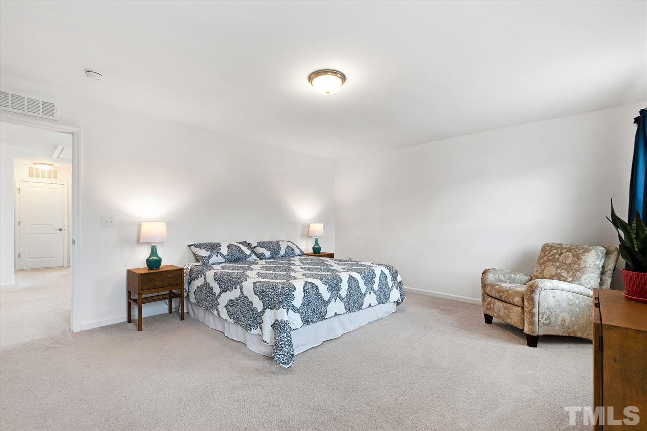 1013 Traditions Meadow Drive Wake Forest, NC 27587 - Photo 15 of 30 a spacious bedroom with a bed and a couch