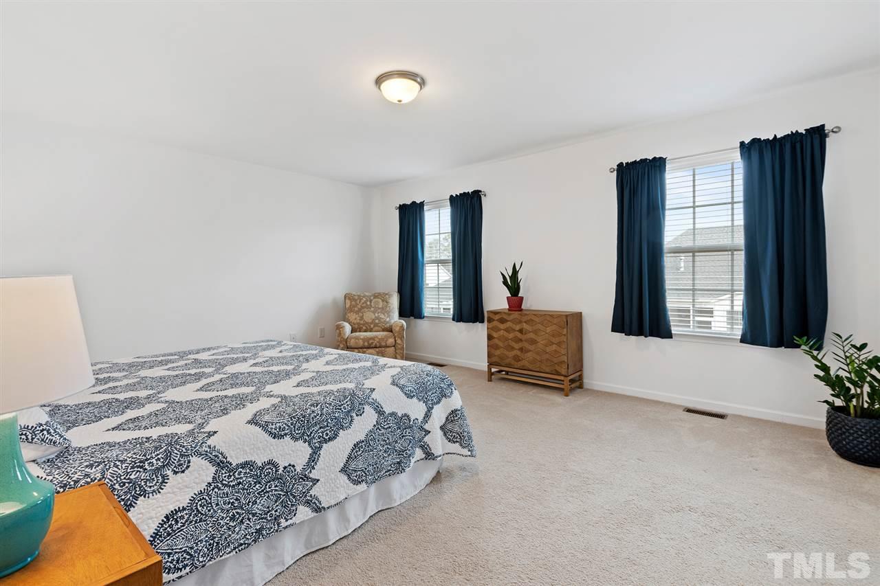 1013 Traditions Meadow Drive Wake Forest, NC 27587 - Photo 16 of 30 a spacious bedroom with a bed and window