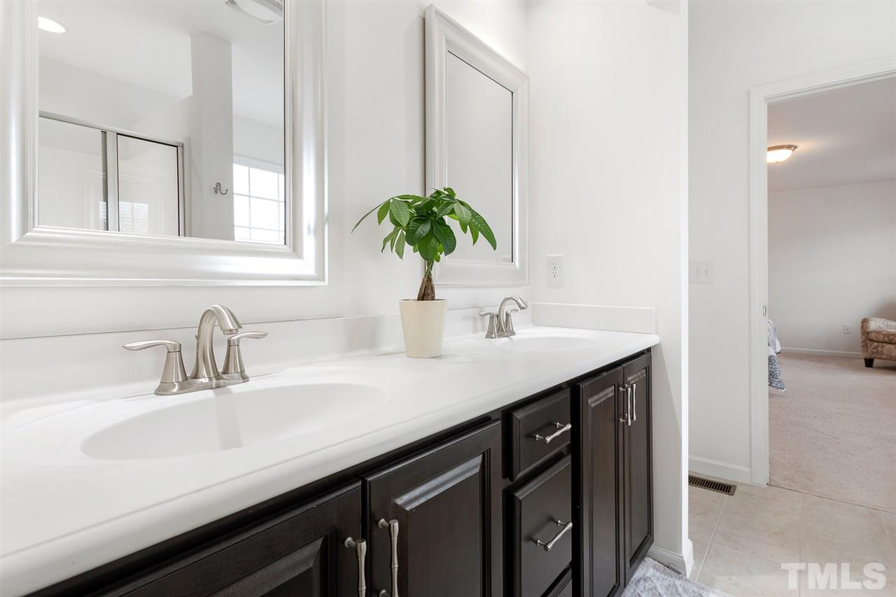 1013 Traditions Meadow Drive Wake Forest, NC 27587 - Photo 17 of 30 a bathroom with a sink and a mirror