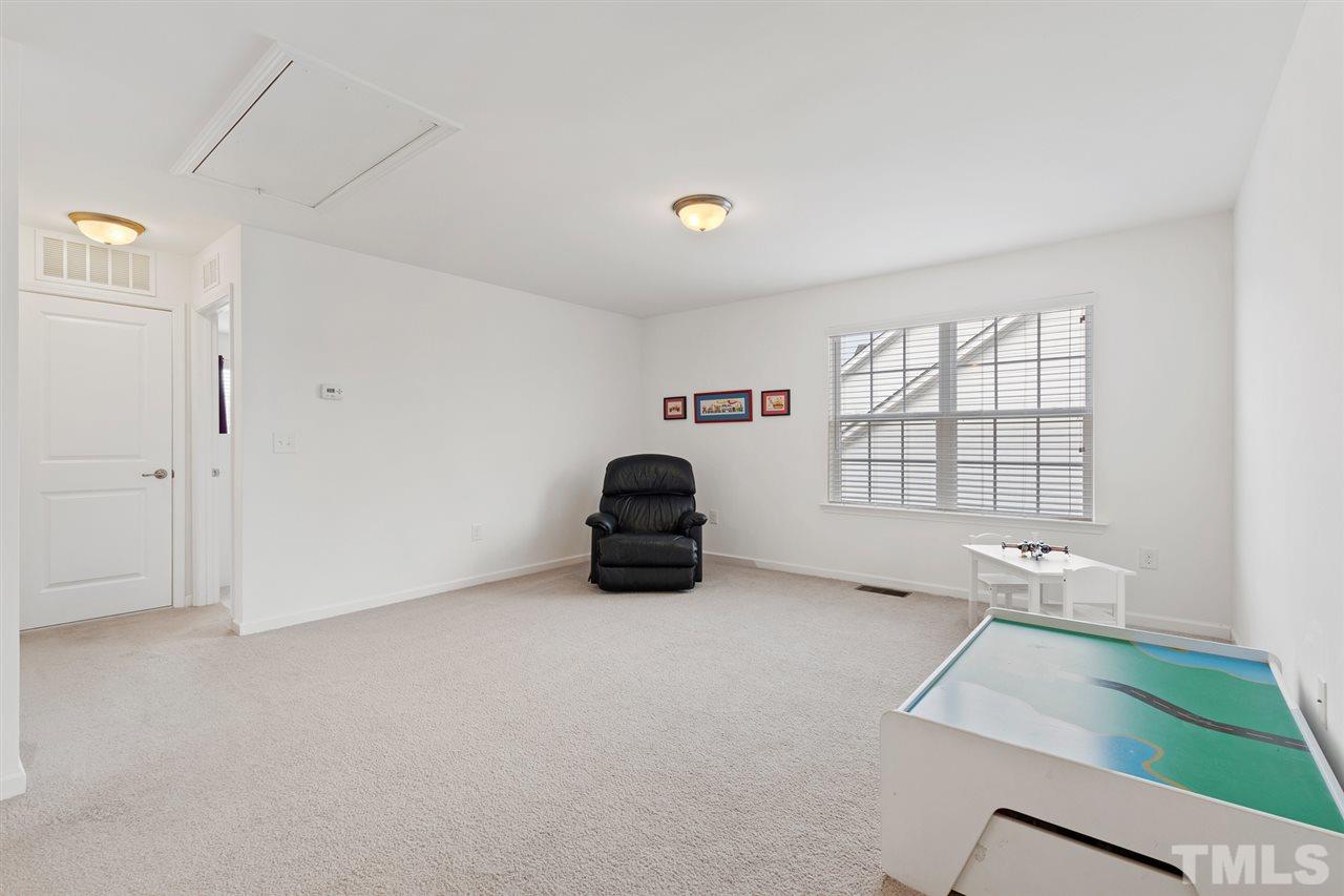 1013 Traditions Meadow Drive Wake Forest, NC 27587 - Photo 20 of 30 a room with a bed and a large window