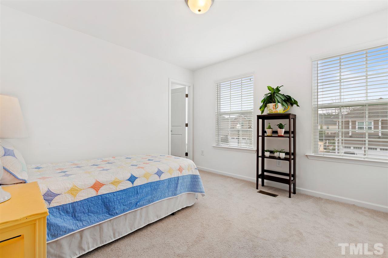 1013 Traditions Meadow Drive Wake Forest, NC 27587 - Photo 25 of 30 a bedroom with a bed and a window