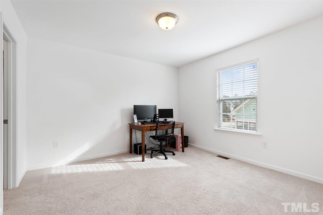 1013 Traditions Meadow Drive Wake Forest, NC 27587 - Photo 26 of 30 a view of a workspace with furniture and a window