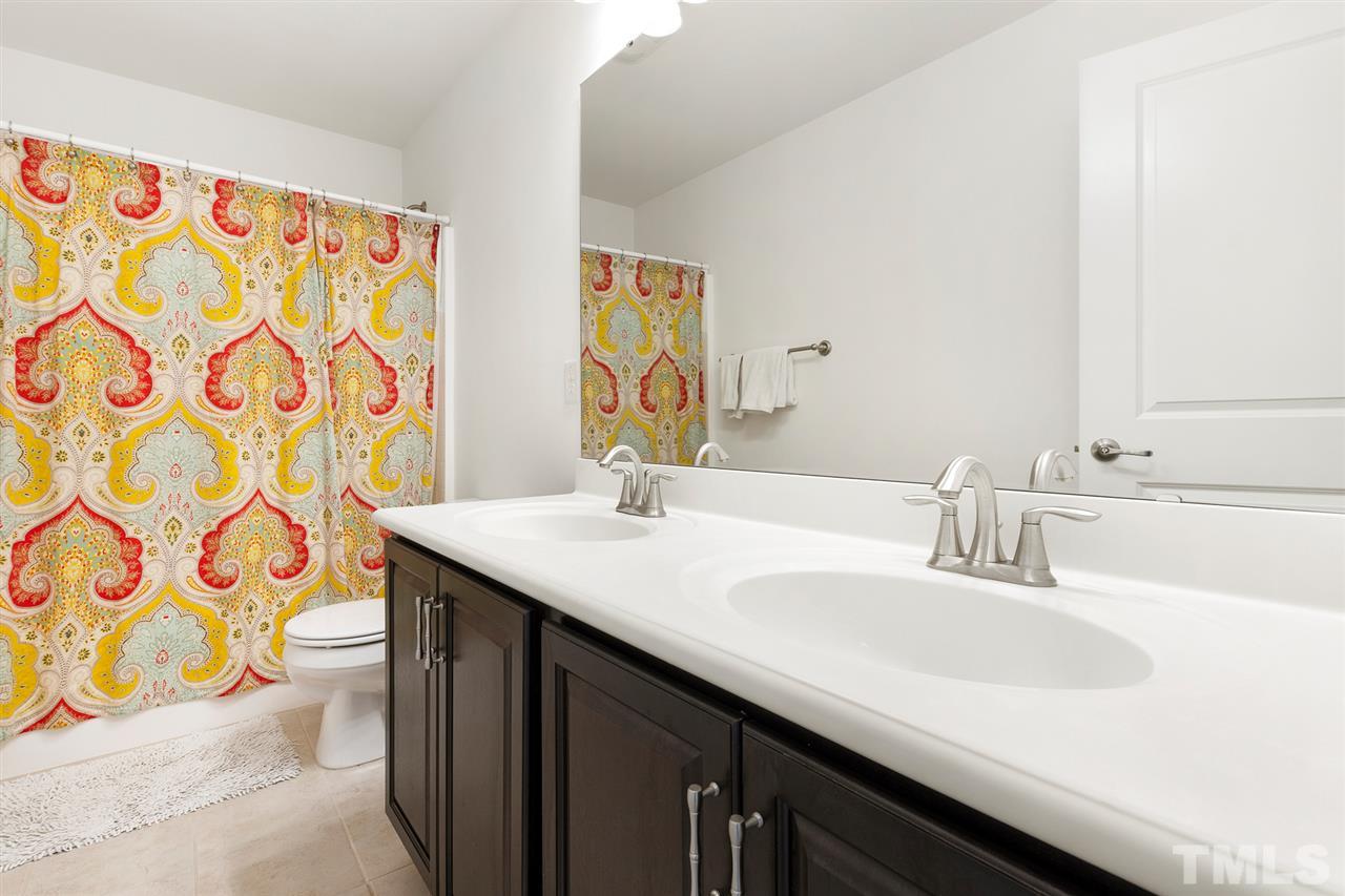 1013 Traditions Meadow Drive Wake Forest, NC 27587 - Photo 27 of 30 a bathroom with a sink and a toilet