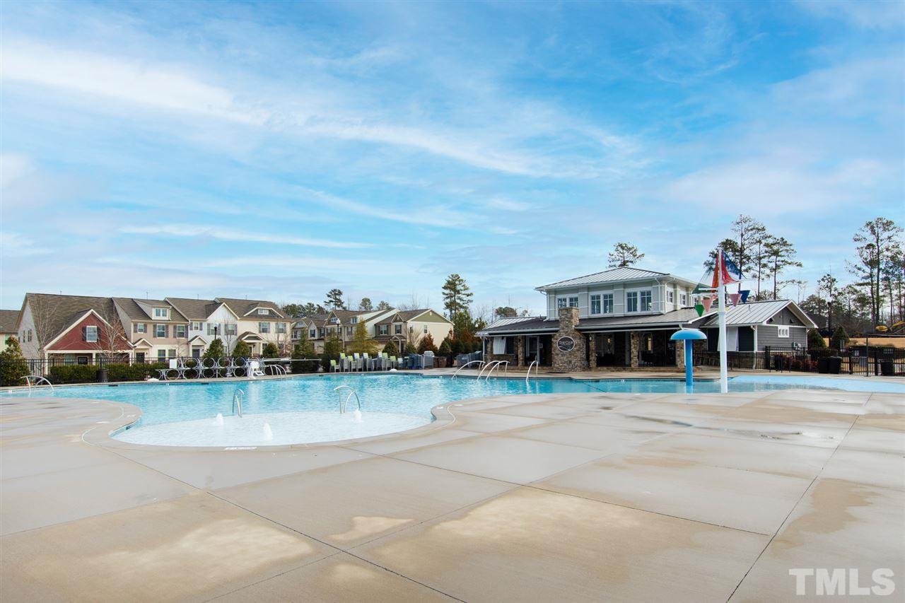 1013 Traditions Meadow Drive Wake Forest, NC 27587 - Photo 29 of 30 a view of swimming pool with outdoor seating and house in the background