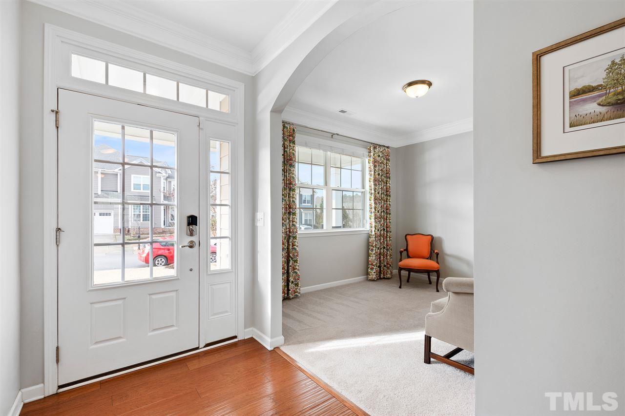 1013 Traditions Meadow Drive Wake Forest, NC 27587 - Photo 4 of 30 a living room with blue couches next to a window with outer view